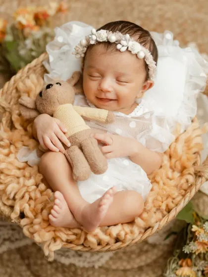 There is nothing more peaceful than a sleeping newborn. This little one gave us the sweetest smile while dreaming, a precious moment from one of our classic newborn photography sessions.