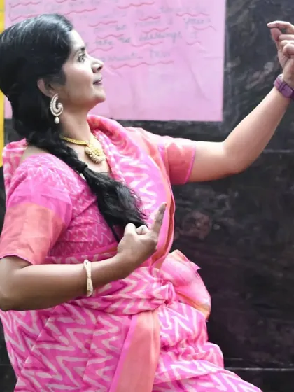 A teacher demonstrating a pose during the Jnana Saraswati temple performance.
