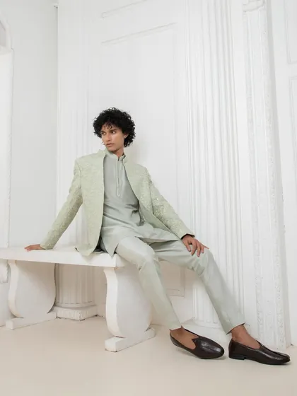 A relaxed pose in the light green tonal set, showcasing its sophisticated ease. This is an ideal choice for an elegant daytime event or a welcome dinner.