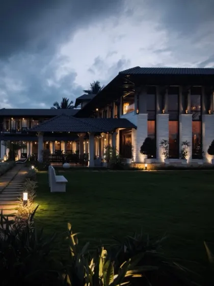 A masterful fusion of form and design. As evening approaches, landscape lighting illuminates the pathway and the grand farmhouse, creating a serene and welcoming atmosphere around the property.