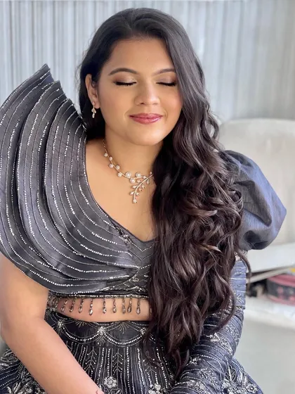 Another look at this stunning client. The soft waves in her hair and the glowing makeup create a look that is both glamorous and effortlessly chic.