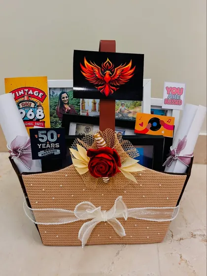 This is what a truly personal gift looks like. For a 50th birthday, I created a themed hamper celebrating a client's love for Kathak dance and cricket, complete with custom posters, photo frames, and other curated items that tell her unique story.