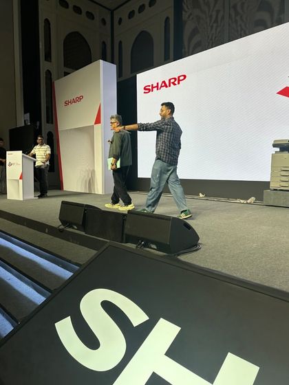Our team guiding a speaker on stage during a rehearsal for the Sharp conference. We provide personal attention to ensure speaker comfort.