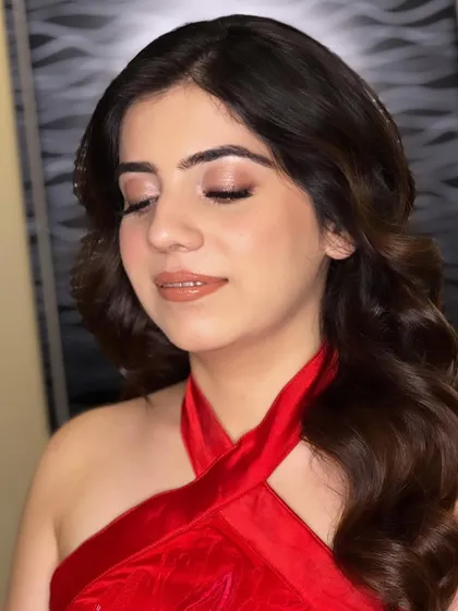 A classic party look. A beautiful red dress paired with soft waves and a neutral, shimmery makeup look that is both festive and elegant.