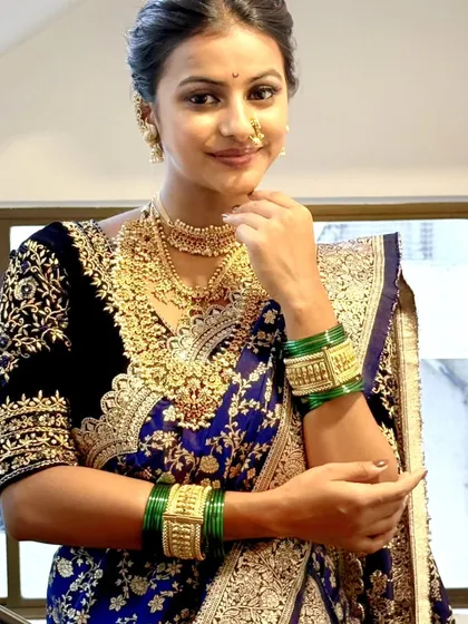 This image highlights the intricate gold jewelry and the rich embroidery of the blouse, paired with a perfectly draped Navari. I help my clients and students understand how to balance the drape with their accessories.