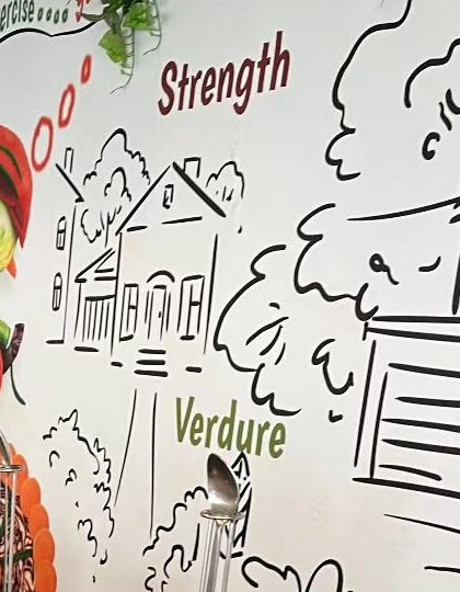 A close-up of the custom wall art at the health-themed corporate event, emphasizing strength and fresh ingredients.