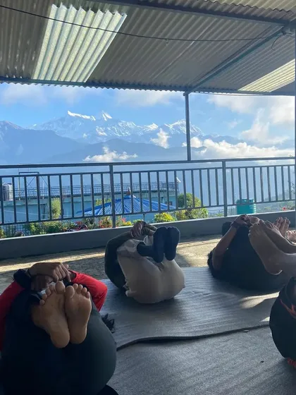 Students resting in a restorative pose during our yoga retreat. With the majestic mountains in the background, finding a state of deep peace and relaxation comes naturally.