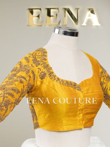 This sunshine yellow raw silk blouse is brought to life with meticulous hand embroidery by my talented artisans. The dense, traditional motifs in antique gold threadwork cover the back and sleeves, creating a piece that radiates warmth and luxury.