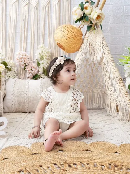 A curious baby girl in a boho setup. The natural textures and soft colors create a calm and beautiful environment for her to explore.