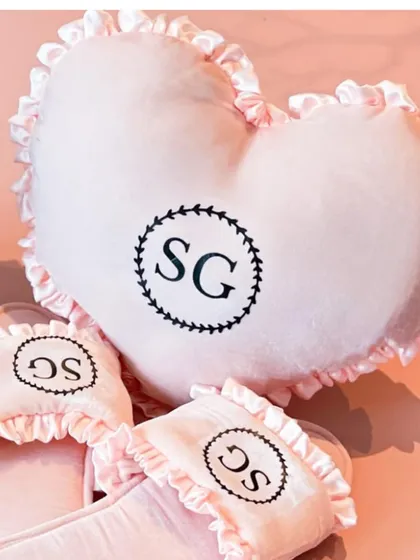 A cozy and cute personalized gift set for the bride, featuring a heart-shaped pillow and slippers with her initials.