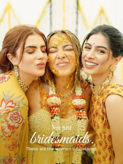 Not just bridesmaids. These are the women who stayed. A bride and her closest friends sharing a moment of pure, uninhibited joy during the haldi.