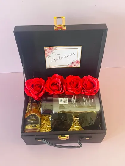 For him, this black suitcase box for Valentine's Day is filled with miniature liquor bottles, sunglasses, and grooming products. It's a sophisticated and fun gift.
