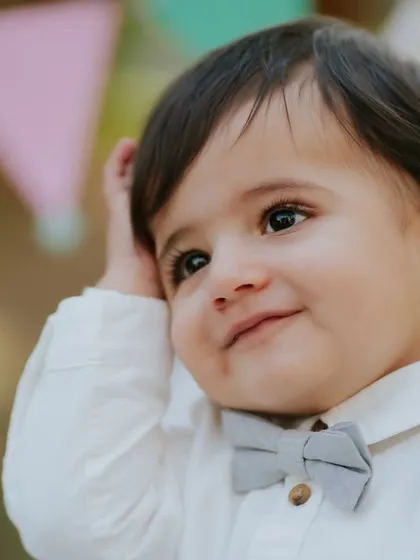 A charming close-up. His sweet, thoughtful expression is beautifully captured during this outdoor pre-birthday session.