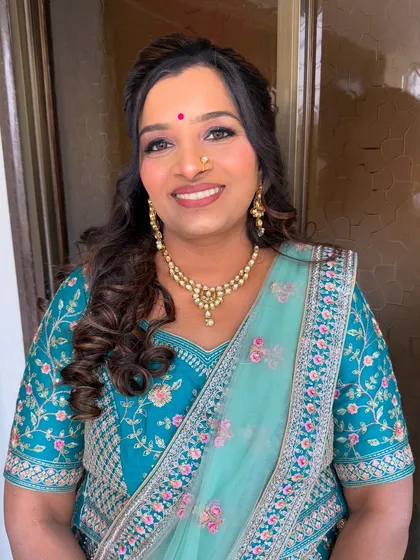 A smiling portrait showing the final look. She looks radiant and happy.