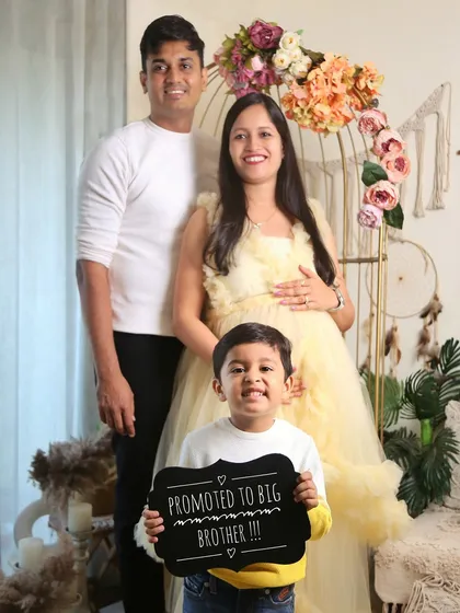 A fun and clear way to announce your news to the world. This family used a "Promoted to Big Brother" sign to share their joy during their maternity photoshoot.