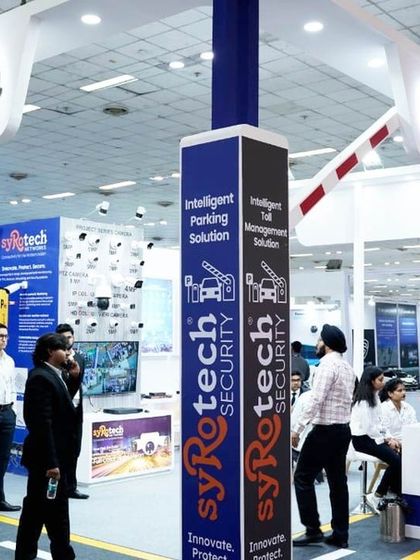 Our impressive booth at the Traffic Infra Tech Expo 2023, featuring our intelligent parking and toll management solutions under large, branded boom barriers.