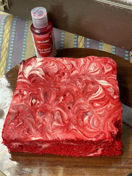 This is my eggless red velvet brownie with a beautiful cheesecake swirl. The vibrant red and white marble effect makes it as visually appealing as it is delicious, with a perfect balance of tangy cream cheese and rich red velvet flavor.