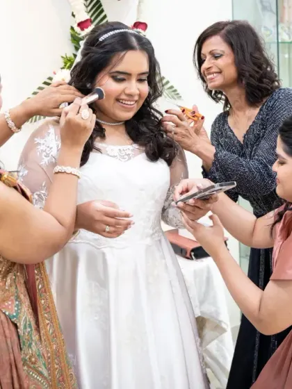 The bride surrounded by her best friends, sharing a laugh and helping with the final touches. These are the precious, unscripted moments of the "getting ready" process.
