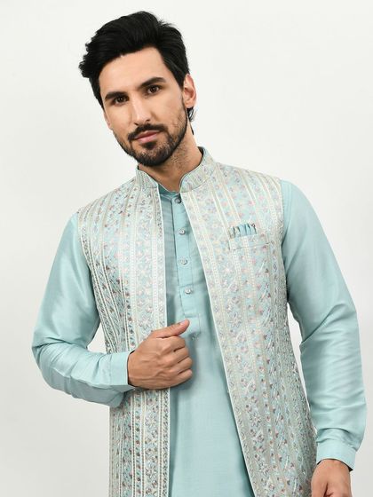 A closer look at the intricate silver embroidery on the light blue jacket. The detail is what makes this simple outfit a statement piece.