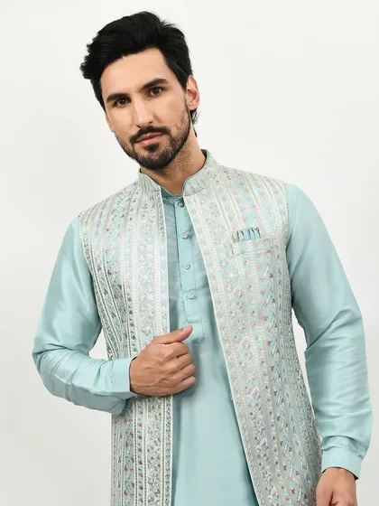 A closer look at the detailed embroidery on this pastel blue kurta jacket. The mirror work and thread work create a look that is both stylish and sophisticated.