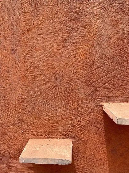 This is the unique texture of 'Thappi', a traditional Rajasthani lime plastering technique. We worked with master artisans to train our all-women team of masons, preserving this sustainable craft and bringing its beauty to modern homes.