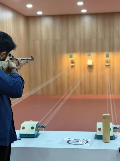 A focused shot of Mr. Omar Haris Nalapad taking aim down the range. We welcome leaders and influencers to discover the discipline and thrill of precision shooting.