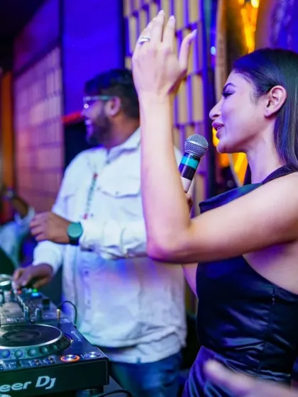 A candid moment on stage with actress Mouni Roy. Whether it's a celebrity appearance or a corporate launch, I ensure the audio-visual experience is seamless and professional.