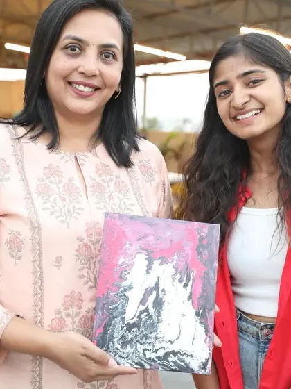 Sharing a proud moment with a participant and her finished fluid art canvas. The joy of completion is a beautiful thing to witness.