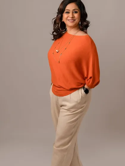 A confident, standing pose that is perfect for a professional profile. The simple background and classic outfit make this a timeless and versatile business portrait.