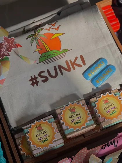 Custom tote bags and other goodies featuring the #SUNKI wedding hashtag. These items were part of a larger beach bachelorette hamper, creating a cohesive and fun theme for the whole group.