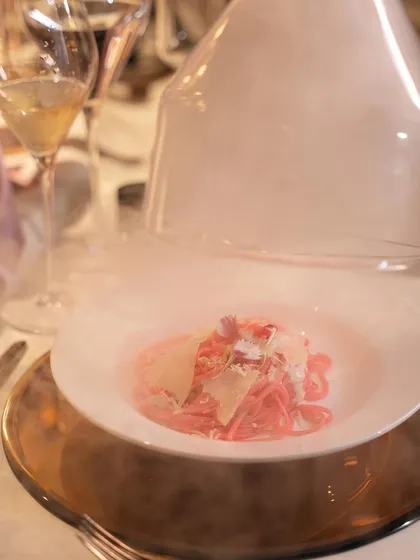 A dramatic presentation of the pink pasta, served under a glass cloche filled with smoke. This bit of tableside theater adds an element of surprise and delight for the guests.