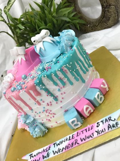 An angled view of the baby shower cake, showcasing the "BABY" blocks and custom banner.