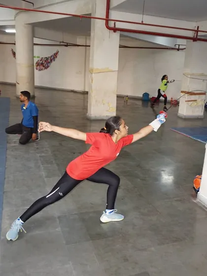 A powerful lunge during target practice. This drill helps fencers develop the explosive power needed to launch a successful attack.