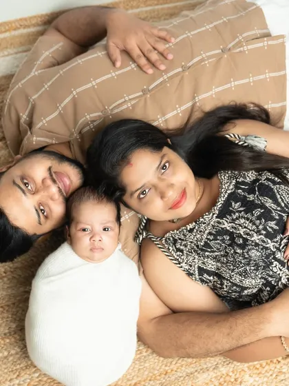 You complete us. This overhead shot of the new family lying together is a unique and intimate perspective, showing how the new baby fits perfectly into their world.