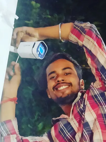 A happy technician with a successful outdoor camera installation. We take pride in our work and in keeping you safe.