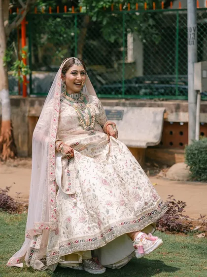 A fun and playful shot of the bride showing off her sneakers under her lehenga! It’s a perfect example of a modern bride who blends tradition with her own unique style.