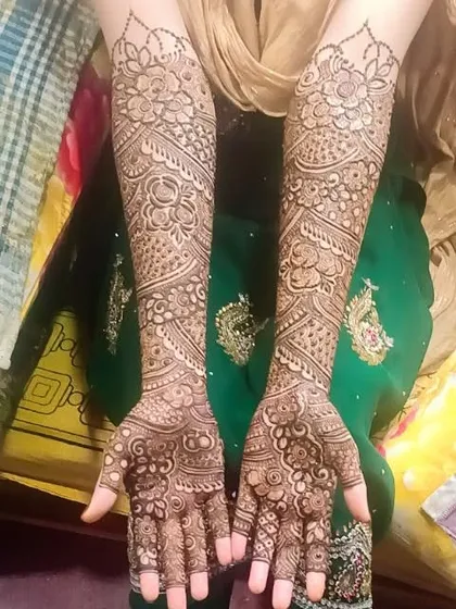 A full view of a traditional bridal design on both arms, showcasing the symmetry and intricacy of the work.