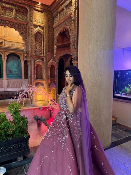 A full view of this elegant wine-colored gown against a beautifully carved backdrop. A perfect choice for a sophisticated engagement party.