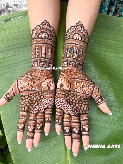 A clean and crisp traditional design with peacocks and architectural elements, set against a natural banana leaf background.