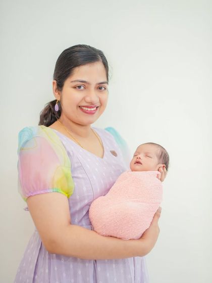 A beautiful portrait of a mother holding her sleeping newborn. My goal is to capture the pride and joy of new parenthood in a simple, elegant style.