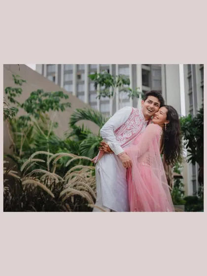 Capturing the simple, happy moments of togetherness. The genuine laughter and easy embrace in this portrait showcase the couple's comfortable and joyful love.