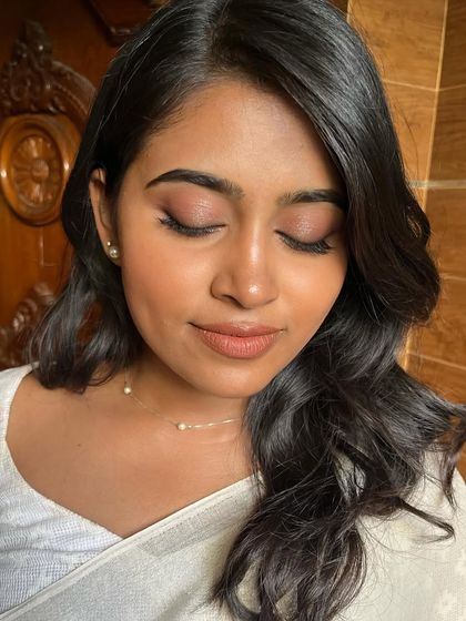 A close-up of the minimal, skin-like makeup. The focus is on healthy, glowing skin and softly defined features.