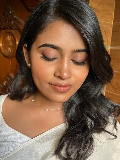 A close-up of the minimal, skin-like makeup. The focus is on healthy, glowing skin and softly defined features.