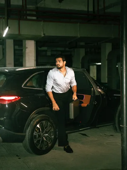 An on-location shoot with a strong narrative feel. The moody lighting of the underground parking lot and the dynamic pose create a cinematic moment, perfect for a men's fashion editorial or a brand campaign that tells a story.