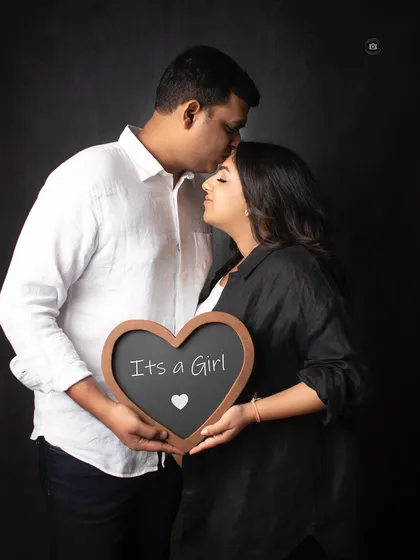 A sweet and intimate "It's a Girl" announcement. The dark background makes the couple's connection the main focus of this beautiful memory.