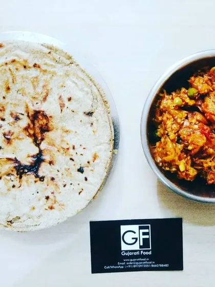 This is a classic Kathiyawadi combination: smoky Ringan no Oro (roasted eggplant mash) served with a traditional Bajri Rotlo (millet flatbread). It's a wholesome and delicious meal option.