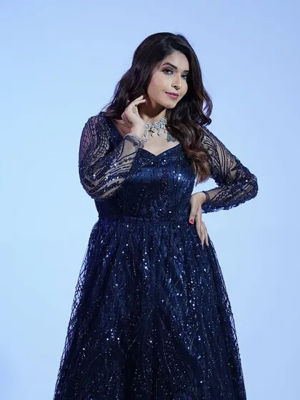 A different angle of the navy blue gown, highlighting the elegant neckline and the way the sequins shimmer under the lights.