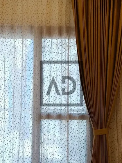 Here is a closer look at a layered curtain setup. The inner sheer curtain features a subtle leaf pattern, adding a decorative touch, while the outer solid curtain provides full privacy and light blocking when needed.