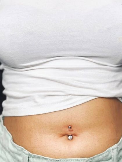 A classic belly piercing with a simple, elegant barbell. This is a timeless look, and I use high-quality, body-safe jewelry for all my clients.