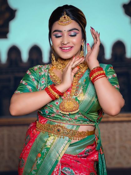 A graceful, dance-like pose that shows the movement of the outfit and the sparkle of the jewellery.